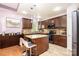 Well-lit kitchen featuring an island, tile floors, stainless steel appliances, and granite countertops at 3837 1St Street Nw Ln, Hickory, NC 28601