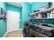 Modern laundry room with front-load washer and dryer and extra storage with shelves of cleaning supplies at 3837 1St Street Nw Ln, Hickory, NC 28601