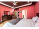 Spacious main bedroom features a dark wood dresser, modern ceiling fan, and entry to the main bathroom at 3837 1St Street Nw Ln, Hickory, NC 28601