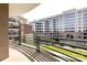 Balcony overlooking a serene courtyard with lush greenery and walking paths at 400 N Church St # 413, Charlotte, NC 28202