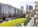 A lovely balcony view of the courtyard, nearby buildings, and city skyscrapers at 400 N Church St # 413, Charlotte, NC 28202
