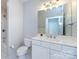 Bathroom with a white vanity, framed mirror, and tub with shower at 400 N Church St # 413, Charlotte, NC 28202