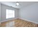 Bright bedroom boasts beautiful hardwood floors, a ceiling fan, and a window for natural light at 400 N Church St # 413, Charlotte, NC 28202