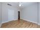 Bright bedroom features wood flooring and ceiling fan at 400 N Church St # 413, Charlotte, NC 28202