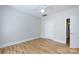This neutral bedroom with hardwood floors features a ceiling fan, closet, and bathroom access at 400 N Church St # 413, Charlotte, NC 28202