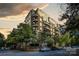 Exterior view of multi-story building with balconies and street parking at 400 N Church St # 413, Charlotte, NC 28202