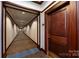 Hallway of a condo with patterned carpet and painted walls at 400 N Church St # 413, Charlotte, NC 28202