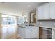 Bright kitchen features stainless steel appliances, white cabinetry and countertops, and hardwood floors at 400 N Church St # 413, Charlotte, NC 28202