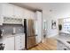 Modern kitchen with stainless steel appliances, white cabinets, and sleek countertops at 400 N Church St # 413, Charlotte, NC 28202