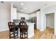 Modern kitchen with white cabinets, stainless steel appliances, and a breakfast bar at 400 N Church St # 413, Charlotte, NC 28202
