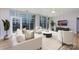 Sun-filled living room with large windows, neutral decor, and stylish furnishings, showcasing a comfortable and modern space at 400 N Church St # 413, Charlotte, NC 28202