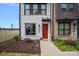 Close-up of modern townhouse facade, landscaping, and a bright red front door for a welcoming entrance at 4002 Tundra Rd, Charlotte, NC 28203