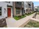 Street view of modern townhouses with varying exterior designs, landscaping, and inviting walkways at 4002 Tundra Rd, Charlotte, NC 28203