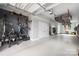 Organized garage with storage solutions, including overhead racks and wall-mounted bike storage at 4002 Tundra Rd, Charlotte, NC 28203