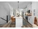 Open-concept kitchen with white cabinetry, a center island, and stainless steel appliances, perfect for entertaining at 4002 Tundra Rd, Charlotte, NC 28203