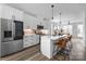 Modern kitchen featuring stainless steel appliances, white cabinetry, and a large center island with seating at 4002 Tundra Rd, Charlotte, NC 28203