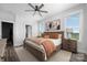 Spacious primary bedroom with neutral tones, a ceiling fan, and serene views at 4002 Tundra Rd, Charlotte, NC 28203