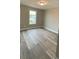 Bright bedroom featuring wood-look flooring and a window with a view at 4172 Saltwood Dr, Hickory, NC 28602