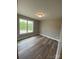 Neutral bedroom with wood-look flooring, window, and lighting at 4172 Saltwood Dr, Hickory, NC 28602