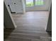 Dining area with newly installed hardwood floors, a window, and a view into the kitchen at 4227 Coopersdale Rd, Charlotte, NC 28273