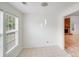 Dining area with tile flooring and view to the backyard, with a brick fireplace nearby at 4227 Coopersdale Rd, Charlotte, NC 28273