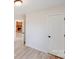 Hallway with durable flooring leading to a living room with a brick fireplace at 4227 Coopersdale Rd, Charlotte, NC 28273