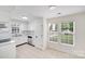 Bright kitchen with white cabinets, stainless steel appliances, tile floors, and natural light at 4227 Coopersdale Rd, Charlotte, NC 28273