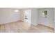 Neutral living room featuring light wood floors, a modern chandelier, and entry to a kitchen at 4227 Coopersdale Rd, Charlotte, NC 28273