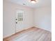 Bright, airy room featuring a door with a multi-pane glass window and neutral decor at 4227 Coopersdale Rd, Charlotte, NC 28273