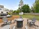 Backyard with a brick patio, fire pit surrounded by Adirondack chairs, wooden fence, and a storage shed at 4346 Walker Rd, Charlotte, NC 28211