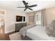 Primary bedroom featuring a ceiling fan, a window with plantation shutters, TV and a dresser at 4346 Walker Rd, Charlotte, NC 28211
