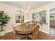 Cozy dining area with hardwood floors, an arched mirror, and an open view to the kitchen at 4346 Walker Rd, Charlotte, NC 28211