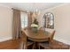 Charming dining room with hardwood floors, chandelier lighting, and elegant window coverings at 4346 Walker Rd, Charlotte, NC 28211