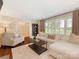 Spacious living room with hardwood floors, a comfortable sofa, and natural light at 4346 Walker Rd, Charlotte, NC 28211