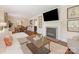 Cozy living room with a fireplace, hardwood floors, and an open view to the dining area at 4346 Walker Rd, Charlotte, NC 28211