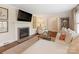 Inviting living room featuring a cozy fireplace, hardwood floors, and ample natural light at 4346 Walker Rd, Charlotte, NC 28211