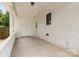 Covered porch featuring brick walls, white trim, and a concrete floor, providing a functional outdoor living area at 4346 Walker Rd, Charlotte, NC 28211