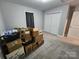 Bedroom featuring cardboard boxes, neutral grey walls, gray carpet, and a closet at 440 Mt Moriah Church Rd, China Grove, NC 28023