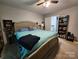 This bedroom has a bed with blue linens, two bookcases, and a ceiling fan at 440 Mt Moriah Church Rd, China Grove, NC 28023