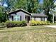 Charming one-story home featuring gray siding, black shutters, and mature landscaping at 440 Mt Moriah Church Rd, China Grove, NC 28023