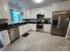 Well-lit kitchen featuring stainless appliances, black countertops, and ample cabinet space at 440 Mt Moriah Church Rd, China Grove, NC 28023