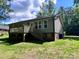 Home with a wooden deck, gray siding, and large windows overlooking the backyard at 440 Mt Moriah Church Rd, China Grove, NC 28023