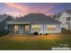 Back exterior with screened-in porch, a grill, well-maintained lawn, and ample outdoor space for entertaining at 471 Lucky Nw Dr, Concord, NC 28027