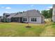 Spacious backyard featuring a screened porch, a well-maintained lawn, and ample space for outdoor activities at 471 Lucky Nw Dr, Concord, NC 28027