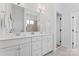 Bright bathroom features dual sinks, white cabinets, a large mirror, and tiled walk-in shower at 471 Lucky Nw Dr, Concord, NC 28027