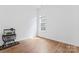 Minimalist bedroom with wood floors, large window, and fish tank at 471 Lucky Nw Dr, Concord, NC 28027