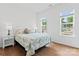 Sunlit bedroom with hardwood floors, two large windows, and queen bed at 471 Lucky Nw Dr, Concord, NC 28027