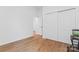 Empty bedroom features closet, bare floors, and fish tank at 471 Lucky Nw Dr, Concord, NC 28027