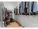 Walk-in closet with hanging racks, shelf, and overhead lighting at 471 Lucky Nw Dr, Concord, NC 28027