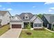 Beautiful home featuring a well-manicured front lawn and a screened front porch, enhancing its curb appeal at 471 Lucky Nw Dr, Concord, NC 28027